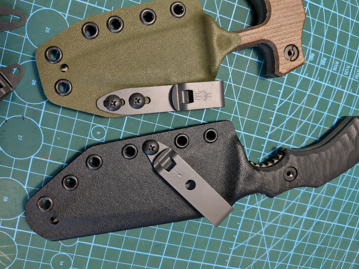 Two AtraxTac knives in olive and black Kydex sheaths with DCC clips