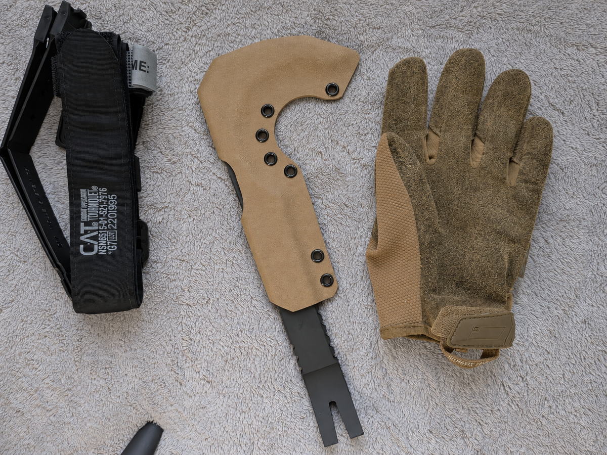 FDE Kydex sheath for NFORCE beside a glove