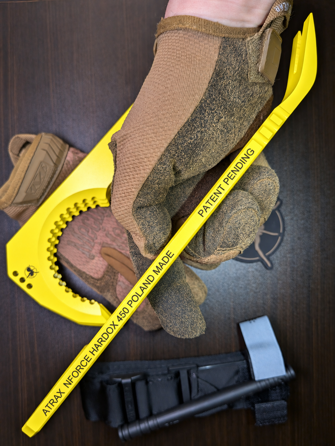 Atrax NFORCE in Lemon Zest Cerakote, original scene with tactical gloves, view 4