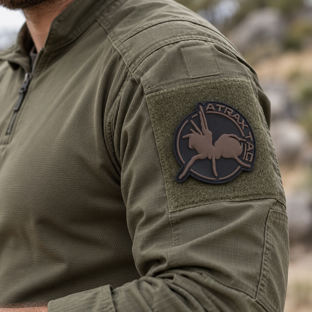 Brown AtraxTac PVC patch on an olive combat shirt sleeve