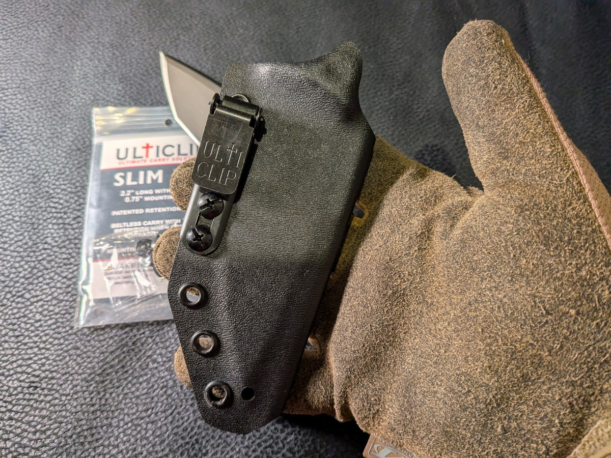 SLIM 2.2 sheath held in a gloved hand